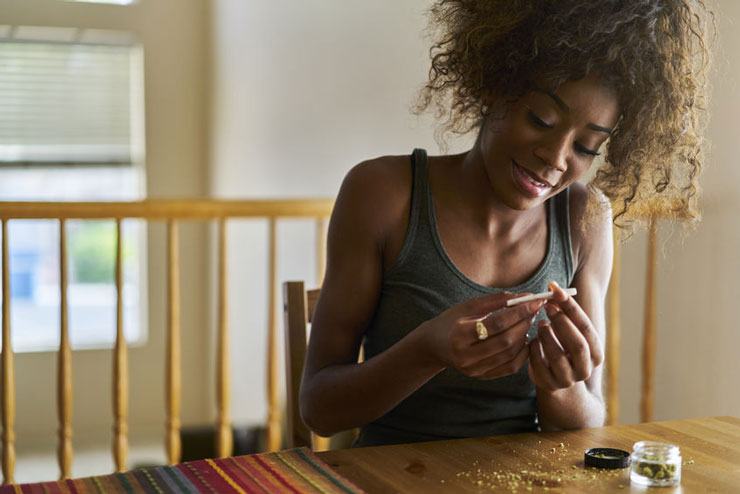woman rolling a joint