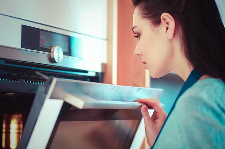 Checking on cookies in the oven